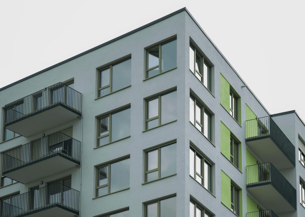 Contemporary architecture of a modern apartment complex with visible balconies and colorful accents.